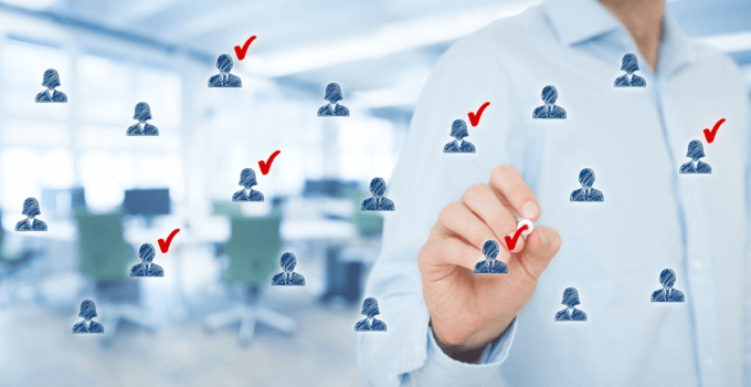 Man Selecting Candidate Icons from Group Floating In Front of Him with Red Check Marks