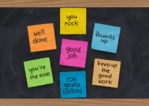 Chalkboard with Multicolored Sticky Notes that Have Encouraging Phrases Written on Them