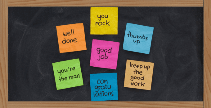 Chalkboard with Multicolored Sticky Notes that Have Encouraging Phrases Written on Them