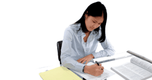 Young Woman Taking Paper Assessment on Table with Books (1)