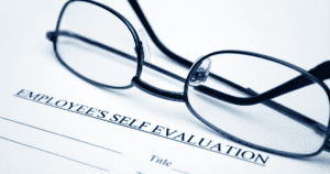 Glasses Set on Top of Employee Self-Evaluation Papers