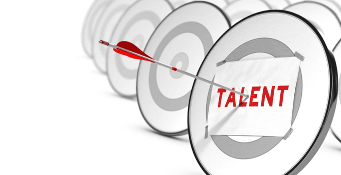 Paper with Talent Typed in Red Taped to a Target and Arrow Penetrating Bullseye Through Paper